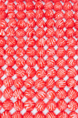 Red round tasty gummy candies as a background.