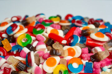 Tasty mix of jelly colorful candies isolated on a white background.