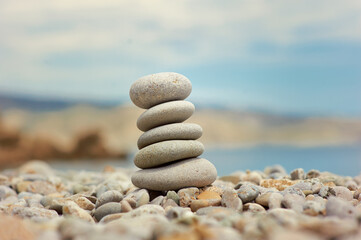 Stack of pebble stones with sea on the background