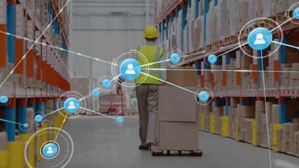 Animation of networks of connection with people icons over caucasian man working in warehouse