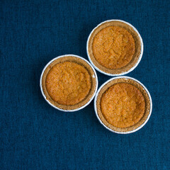 Mini sweet potato pies on blue textured background