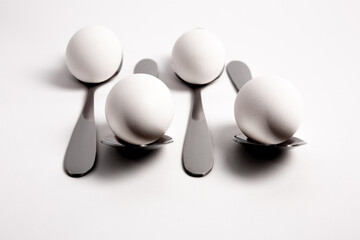Chicken egg on metal forks, spoons isolated on white background close-up.
An egg that is set on top of two forks, spoons. Eggs have so many uses from diet to baking recipes.