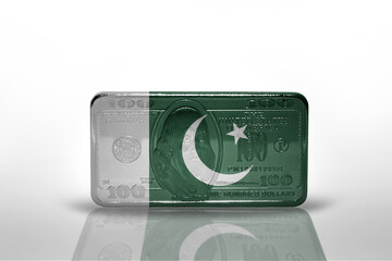 national flag of pakistan on the dollar money banknote on the white background .