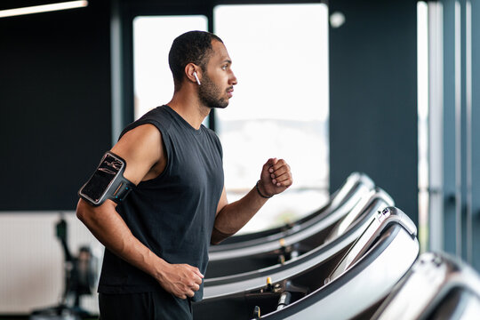 Sport Training. Motivated African American Man Using Treadmill At Gym,