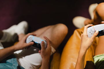 young couple playing games on game console