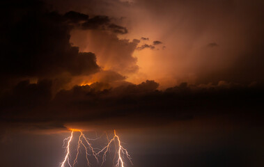 Fork lightning striking down during summer storm