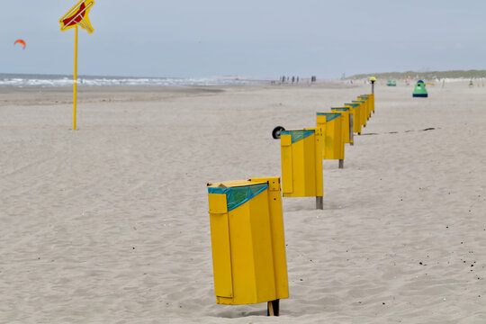 yellow litter bins on the beach