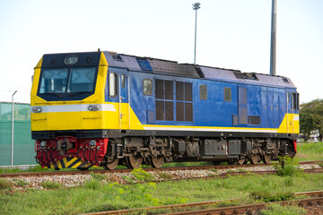 Fototapeta premium The train is running to the destination station when the sun is going down in the evening in a port way in Thailand.