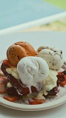 Ice cream waffles, Thai tea flavor, coconut milk and chocolate chips topped with fresh strawberries at a seaside café. Close up Shot.