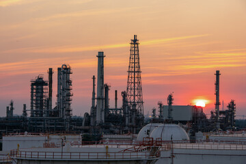 Oil refinery plant from industry zone, Aerial view oil and gas petrochemical industrial, Refinery factory oil storage tank and pipeline steel Oil tankers are loading oil to the ship.