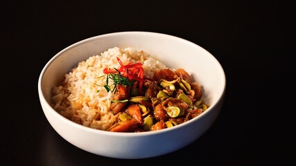 Stir Fried Sataw and Shrimp with Southern Curry Paste on rice. on black background.