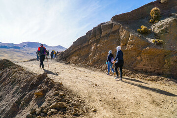 Unidentified tourists walking on the Rainbow Mountain (Vinicunca Montaña de Siete Colores - Spanish) in Cusco, Peru