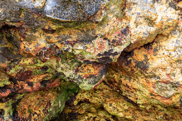 rocks near the beach with a great variety of veins of different colors and minerals, live and natural colored rocks