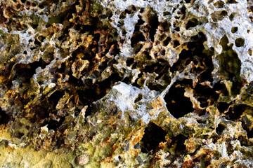 rocks near the beach with a great variety of veins of different colors and minerals, live and natural colored rocks