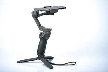 Gray gimball and mobile phone on white background taken in photo studio.