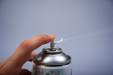 Metal spray on gray background.
