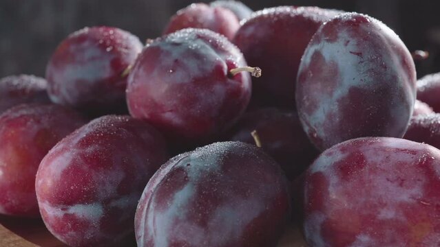 plum on a wooden rotating cup on a dark background