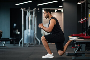 Fototapeta na wymiar Portrait Of Athletic Black Man Making Bulgarian Split Squat Exercise At Gym