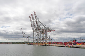 Southampton, England, UK. 2022. Large cranes waterside at a container ship terminal in southern England.