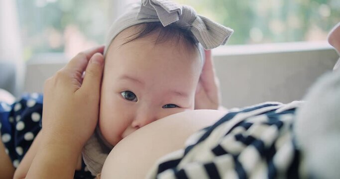 Close up portrait happiness people Asian family little baby girl sucking milk from mother, woman mom breastfeeding cute infant daughter care with love, motherhood childhood parenting kid at home