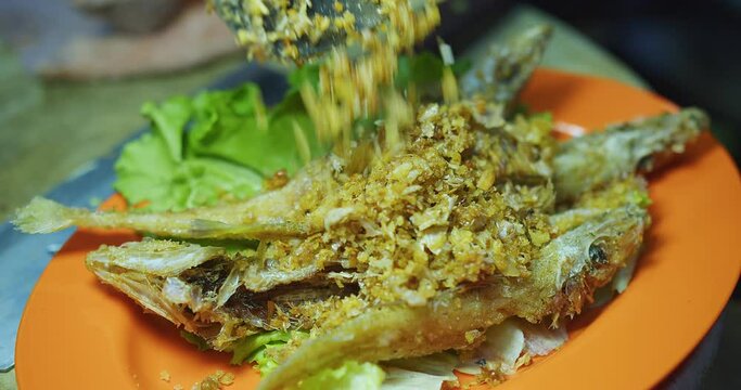Close up thai food deep fried crispy fish with garlic in plate at the kitchen