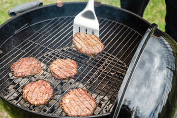 Selective focus of fresh delicious burger cutlets grilling on bbq grill