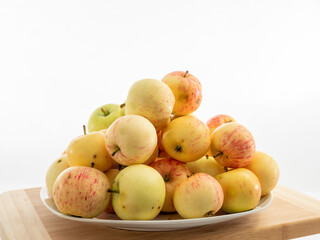 Fresh red apples on a wooden table with a white background.