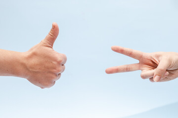 Two hands gesturing on a blue background