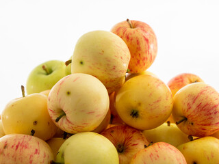 Fresh red apples on a wooden table with a white background.