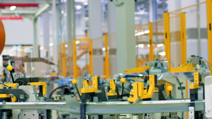 Robotic mechanism, industrial robot iin motion at the modern factory. Scene. Concept of heavy industry and machinery.