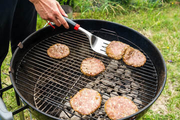 Selective focus of fresh delicious burger cutlets grilling on bbq grill