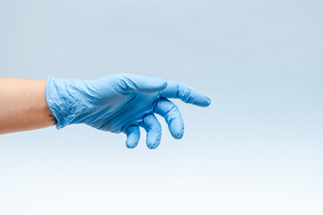 Hand in blue glove isolated on blue background