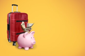 Travel.Vacation money saving concept, piggy bank beach vacation. Miniature luggage