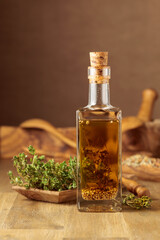 Bottle of olive oil with thyme and spices.