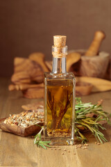 Fototapeta na wymiar Bottle of olive oil with rosemary and spices.