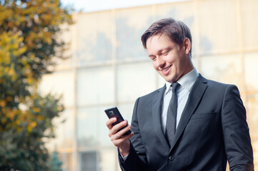 young business man iholding mobile phone
