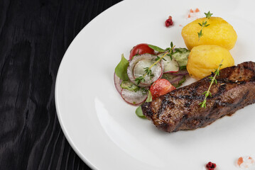 Grilled black angus strip loin steak with vegetables