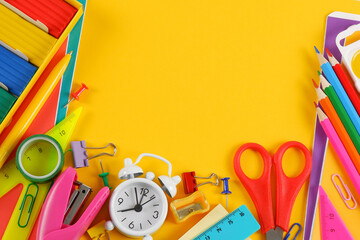 Lots of colorful stationery with an empty space for text on a yellow background.Purchases of office supplies online through online stores, discounts and promotions for office and school supplies