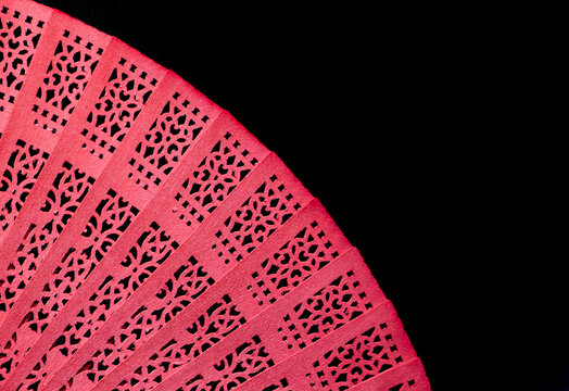 Red fan with details in the wood and thread tassel attached to the handle. Andalusian fan. Spanish costume accessory. Color fans.