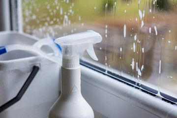 Window cleaning detergent. Washing the glass on the windows with cleaning spray. Selective soft...