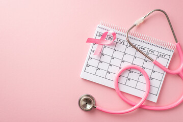 Breast cancer prevention concept. Top view photo of pink ribbon calendar and stethoscope on isolated pastel pink background