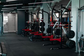 Fototapeta na wymiar Heavy Weight Lifting Equipment Standing In A Row In Empty Gym,
