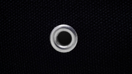 metal rivet, eyelet on black canvas fabric