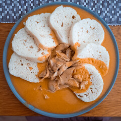 Traditional chicken hen on paprika or paprica creamy sauce with bread dumlings, typical czech food