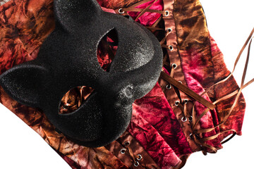 Women's carnival accessories: a black cat mask with burgundy velvet corset, isolated.