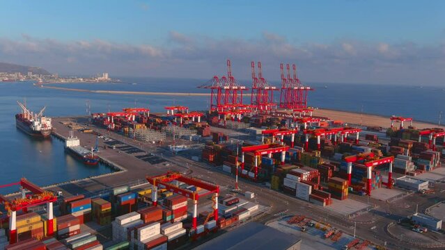Haifa port with cranes and containers, sunrise, 2022 
Drone view over cranes and cargo containers, Haifa,Israel,July,27,2022
