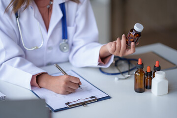 Your doctor woman is evaluating and reviewing the quality of the medicines and vaccines for their intended treatment or if they have any side effects.