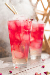 Summer drink with ice. Two glasses of full fresh lemonade with rose water. Homemade drink ovshala with a beautiful gradient. Vertical position