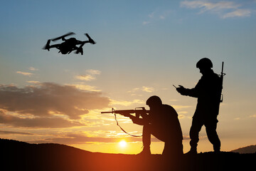 Fototapeta na wymiar Silhouettes of soldiers are using drone and laptop computer for scouting during military operation.