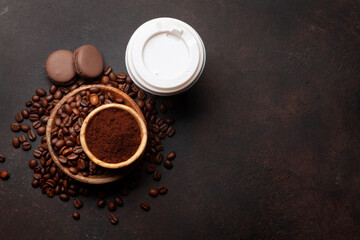 Takeaway cup, roasted coffee beans and ground coffee